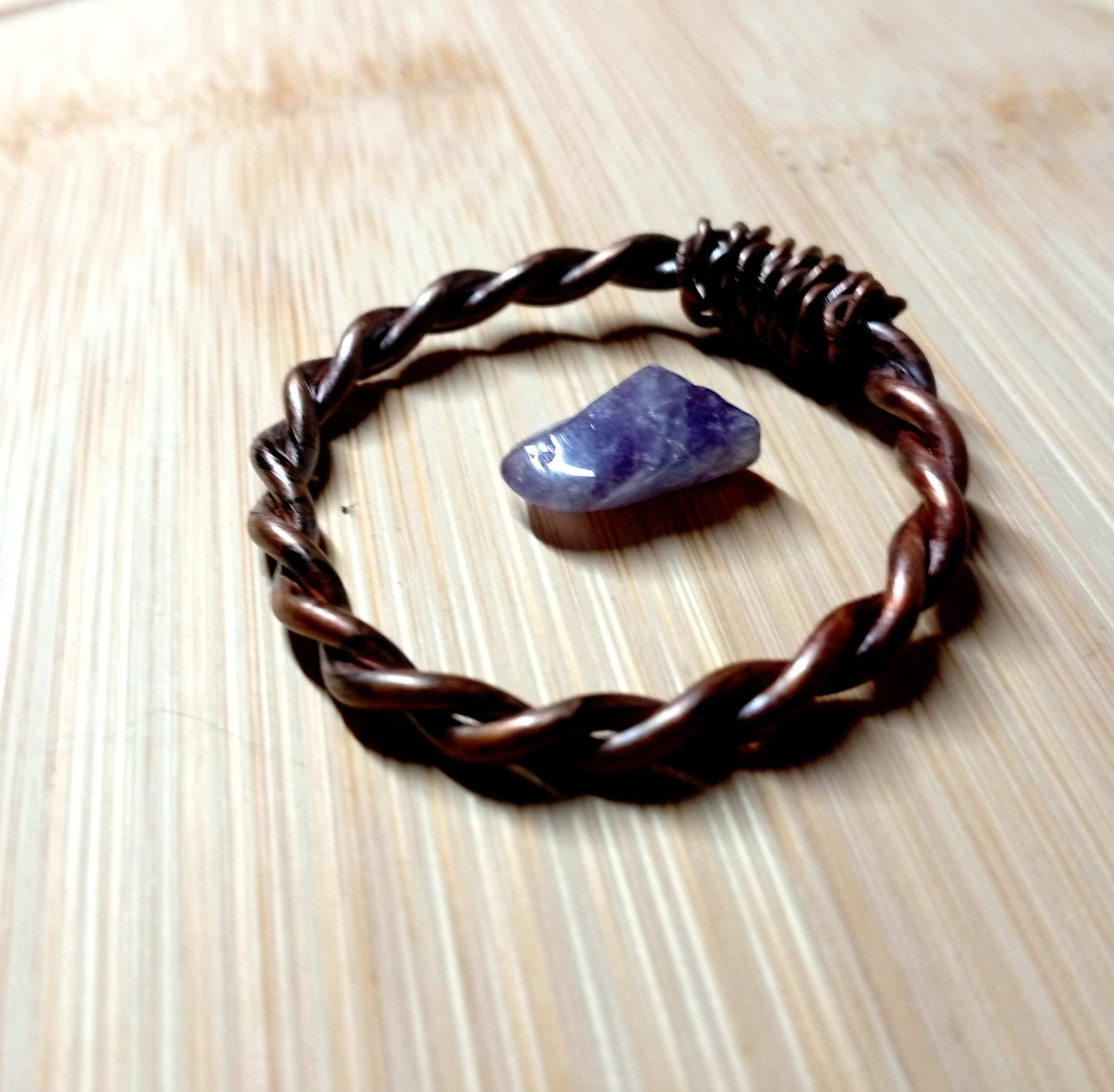 Bronze-Oil Copper Tensor Ring 1/4 Royal Cubit with amethyst on wood surface