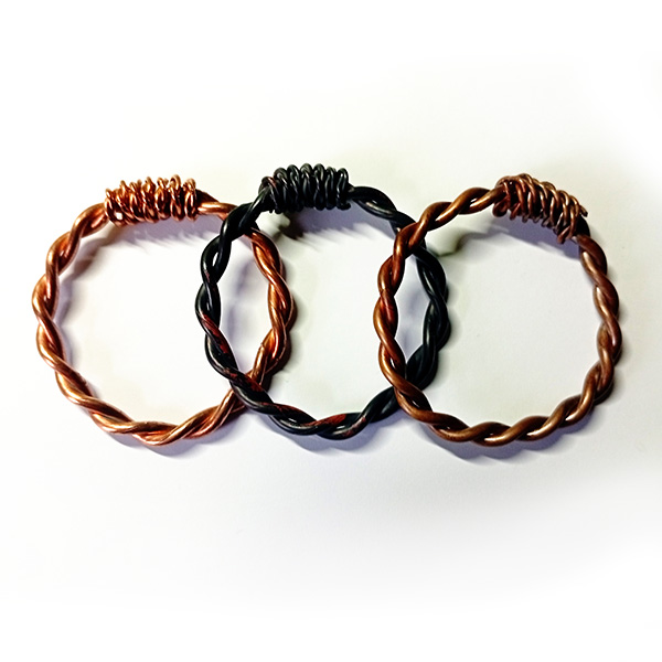 Three handcrafted copper tensor rings (RAW, Fire-Burned, Bronze-Oil) in 1/4 Royal Cubit size, placed side by side on a white background.