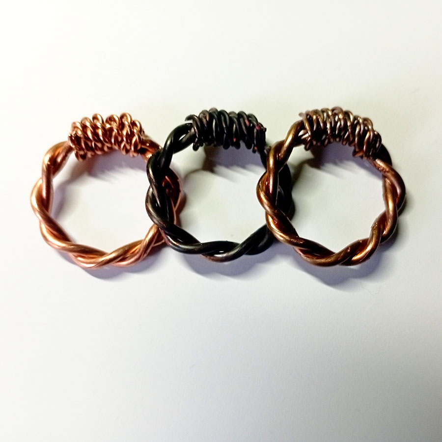 Three handcrafted copper tensor rings (RAW, Fire-Burned, Bronze-Oil) in 1/4 Royal Cubit size, placed side by side on a white background.